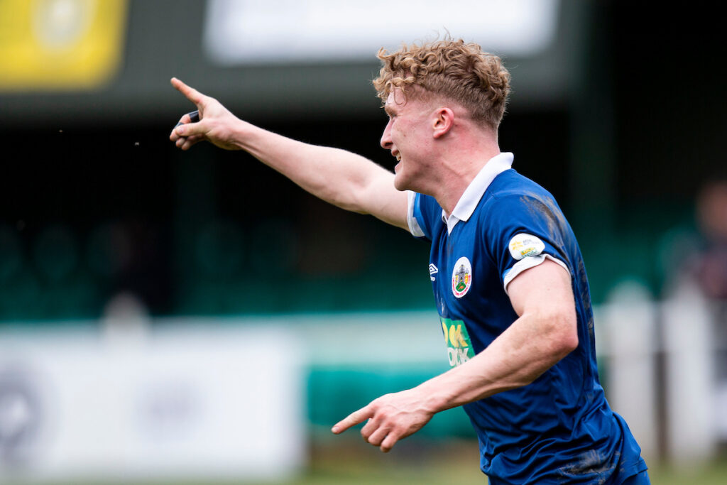 Ben Lockley of Denbigh Town celebrates scoring his sides sixth goal. Bridgend Street v Denbigh Town in the FAW Amateur Trophy at Victoria Park on the 18th March 2023
