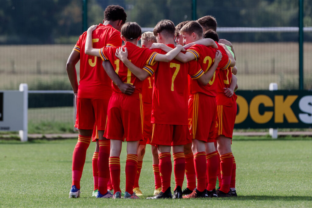 Wales team huddle during the Under-15 UEFA Development Tournament fixture between Wales U15 & Belgium U15 at Central Park, Denbigh, Wales on August 28th 2022